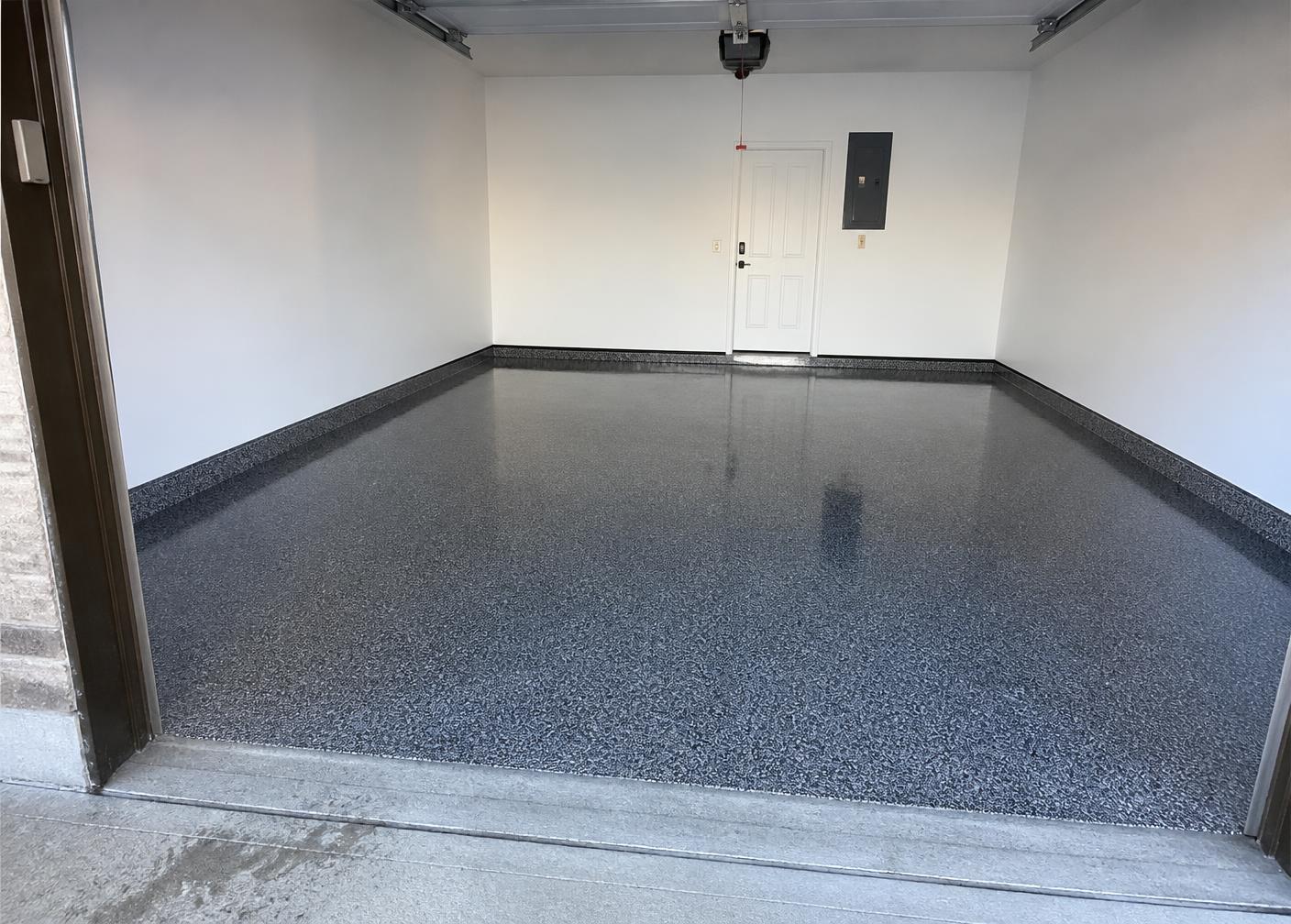 Same garage floor after a gray flake polyaspartic coating installation