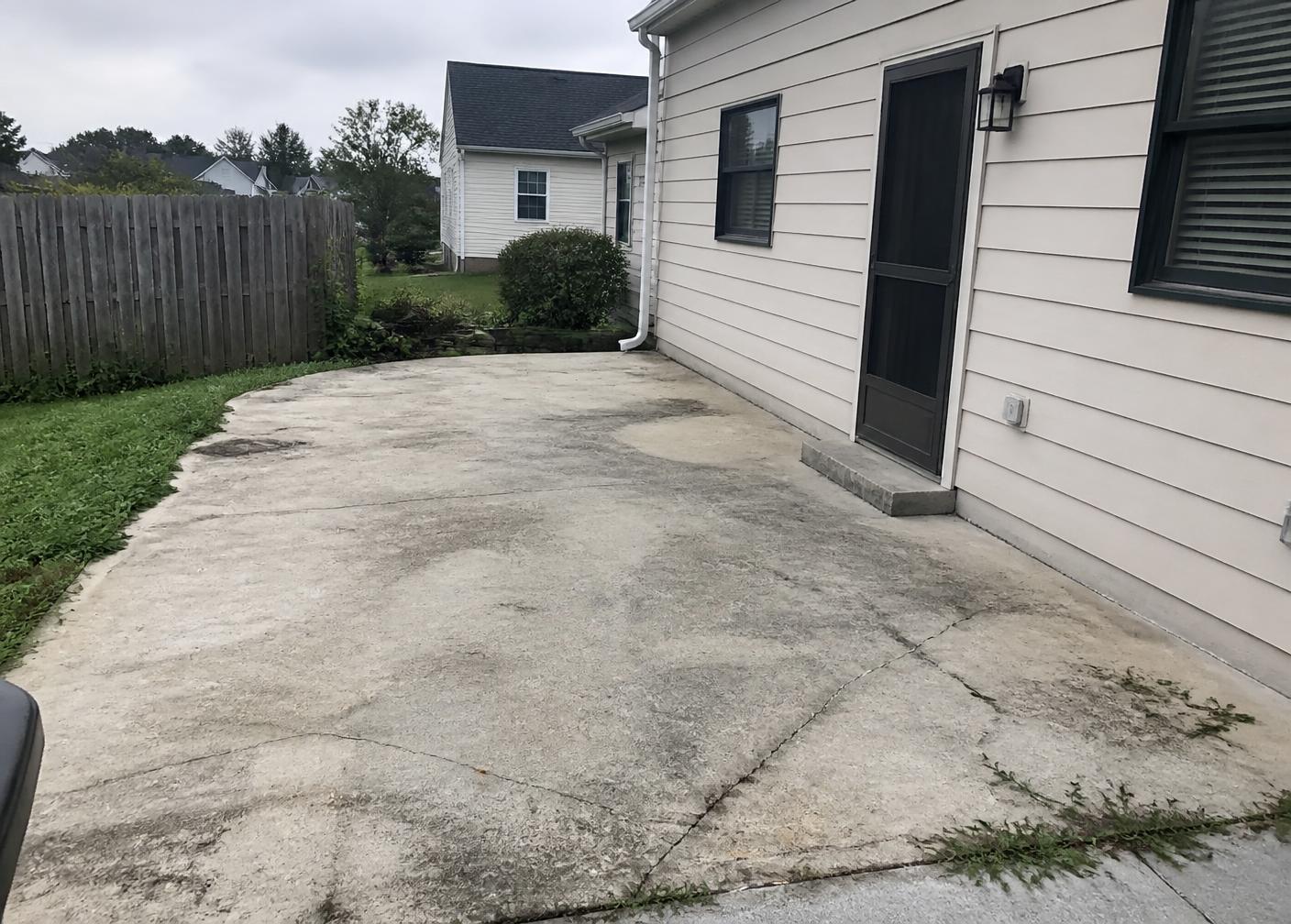 Faded cracked concrete patio slab before coating