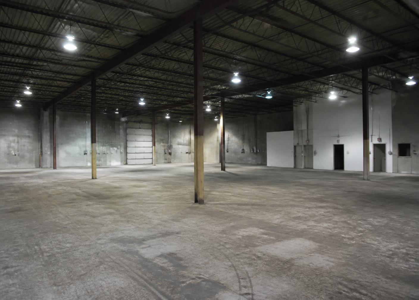 Worn dusty warehouse concrete floor before coating